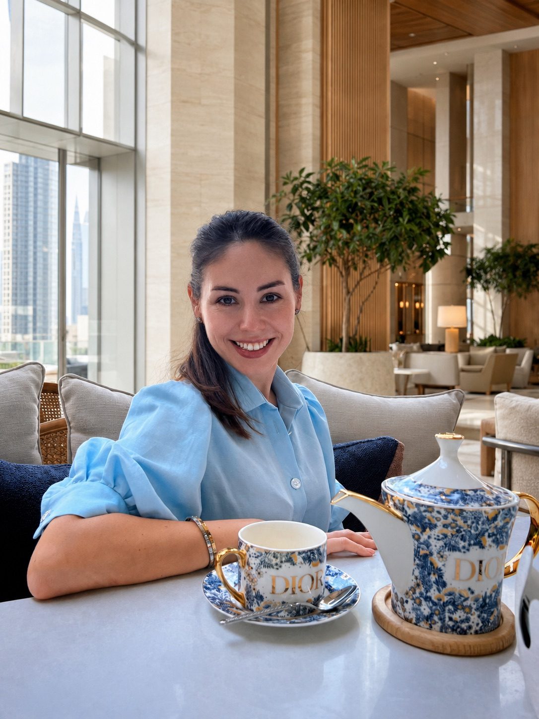 Anastasia in a hotel lobby, Downtown Dubai skyline in the background